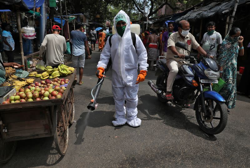 Municipal worker sanitizes street in Kolkata