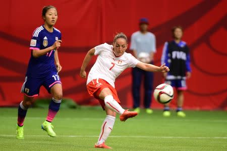 Jun 8, 2015; Vancouver, British Columbia, CAN; Switzerland midfielder Martina Moser (7) kicks the ball in front of Japan forward Yuki Ogimi (17) during the second half in a Group C soccer match in the 2015 women's World Cup at BC Place Stadium. Mandatory Credit: Anne-Marie Sorvin-USA TODAY Sports
