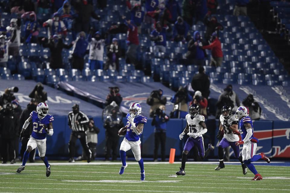 Buffalo Bills cornerback Taron Johnson (24) runs back an interception for a touchdown during the second half of an NFL divisional round football game against the Baltimore Ravens Saturday, Jan. 16, 2021, in Orchard Park, N.Y. (AP Photo/Adrian Kraus)