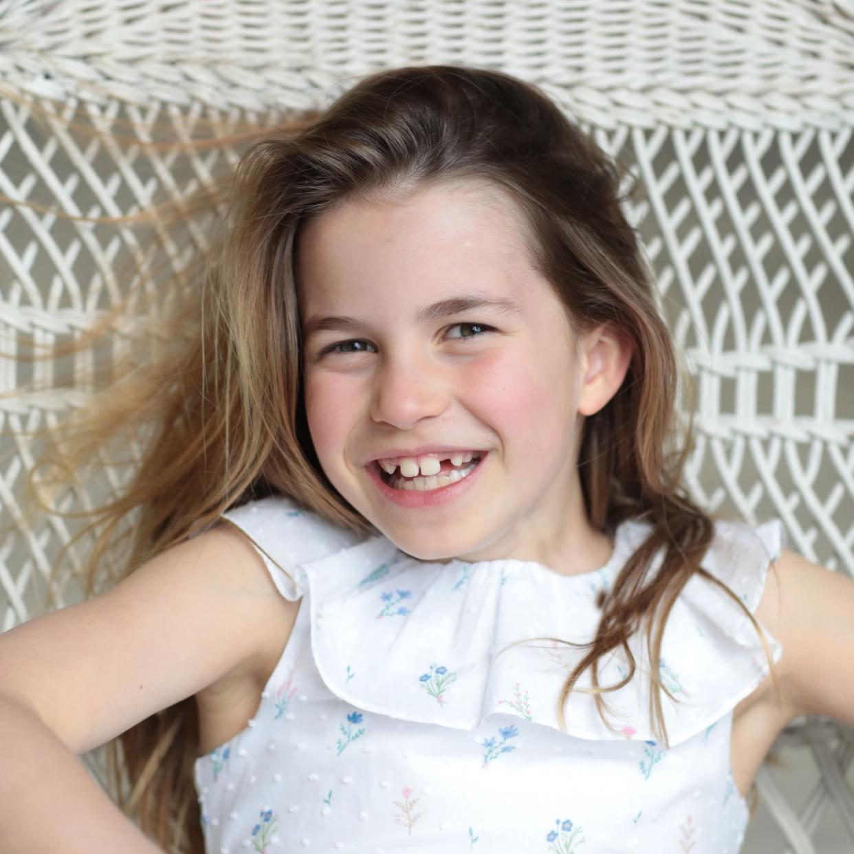  Princess Charlotte smiling widely in a hammock. 