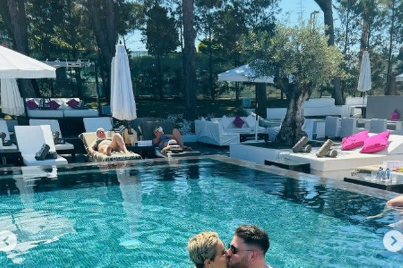 She posted a picture kissing her husband Ben in the pool on holiday