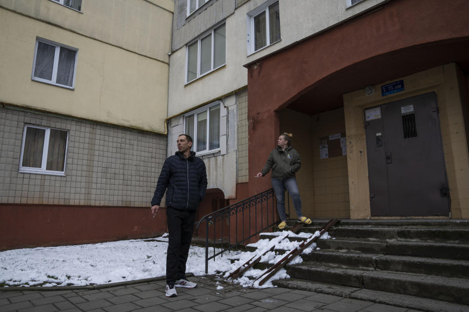 Iryna and Volodymyr, internally displaced from Irpin, smoke, outside the apartment building they took refuge in with four other adults from Irpin, in Lviv, western Ukraine, Sunday, April 3, 2022. Iryna and her husband Volodymyr were trapped for days between Ukrainian and Russian forces and quickly learned to distinguish between incoming and outgoing fire. They took shelter in a basement and whenever the shelling eased, they climbed out to shout to their neighbors to see if they were still alive. (AP Photo/Nariman El-Mofty)