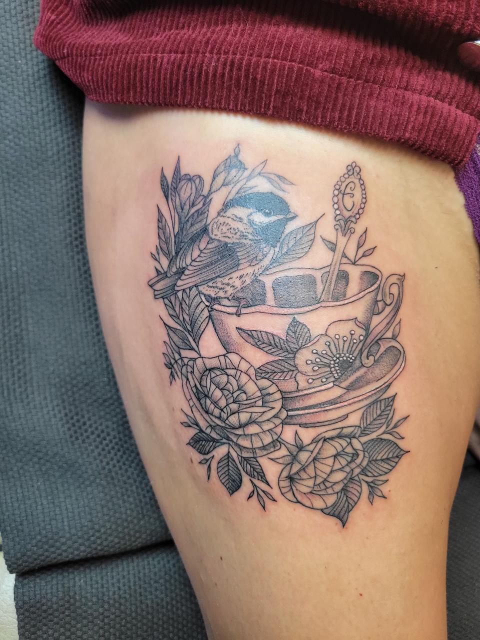 Vicky Suprenand's chickadee and teacup tattoo represents her mother, who is British and loves birds. She had this tattoo done in England.