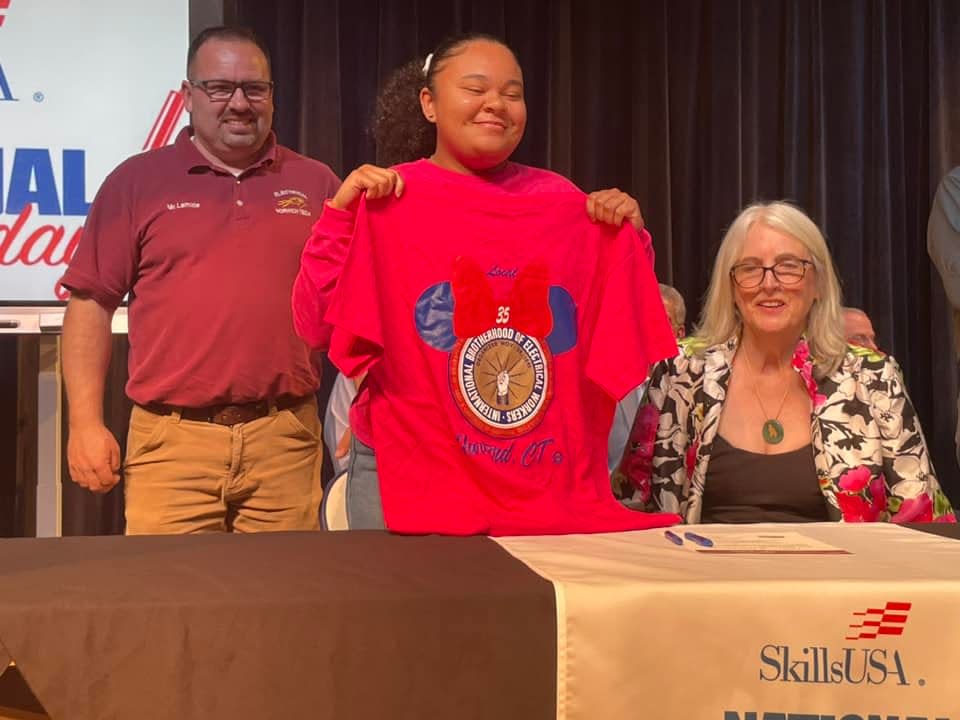 Imani Johnson holds a shirt for the IBEW Local 35. Johnson committed to the union during Norwich Tech's Skills USA National Signing Day Tuesday.