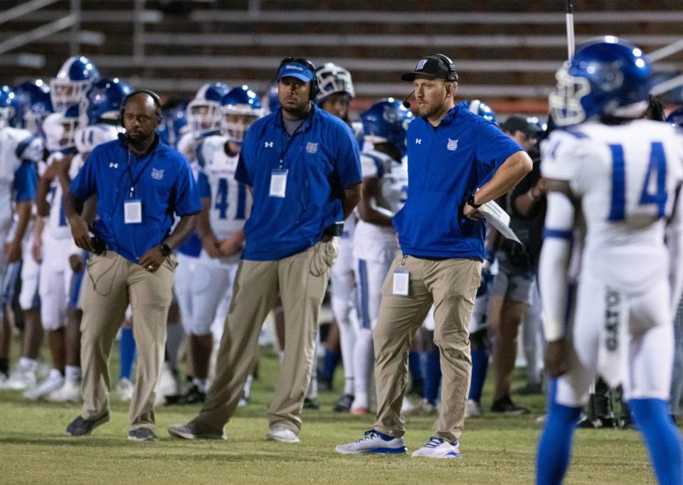 Wildcats head coach Ryan Onkka, right, keeps his eye on the action during the Washington vs Escambia football game at Escambia High School in Pensacola on Friday, Sept. 29, 2023.