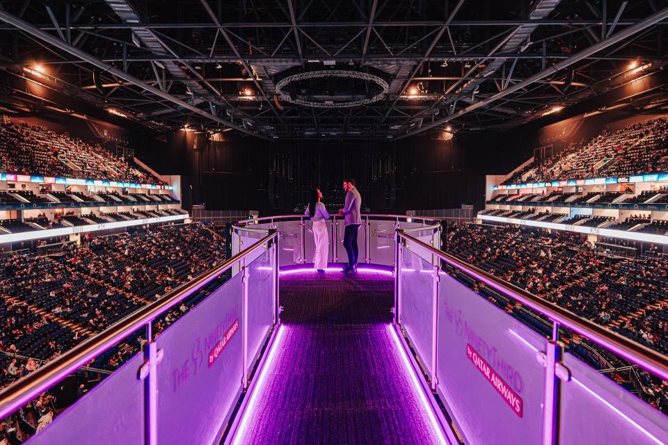 Two people chat at the end of the walkway at The O2's The NinetyThird by Qatar Airways