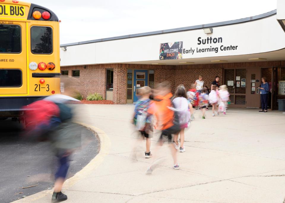 Students stream into Tecumseh's Sutton Early Learning Center for the new school year's first day of classes Wednesday.