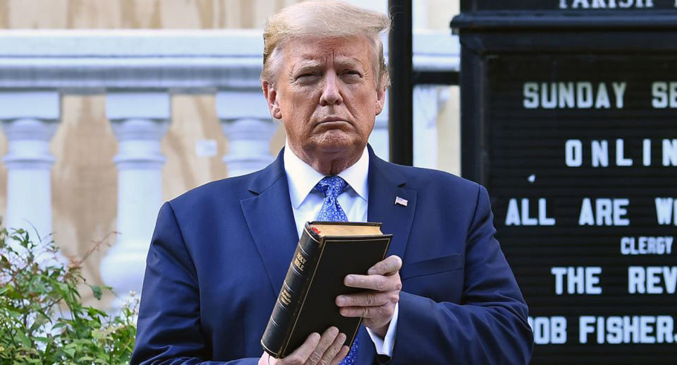 Pictured is Donald Trump holding a bible while standing outside the St John's Church. 