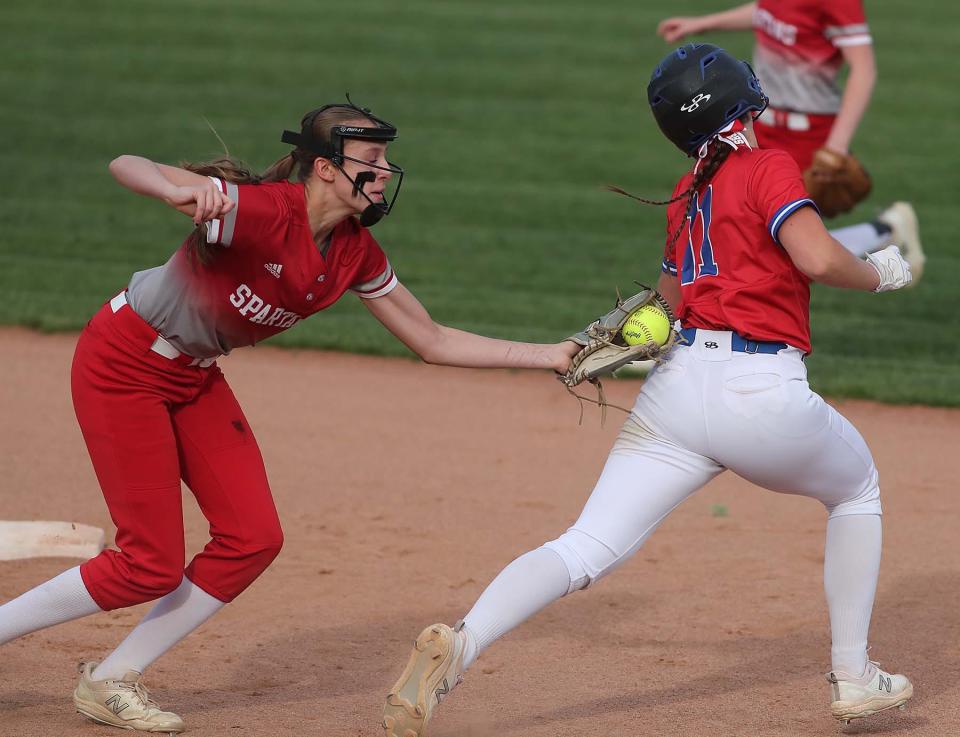 Kendall Crytzer, left, of Springfield tags out Ava Ash of Revere who is caught off base during the first inning of their division II district semifinal game at Firestone Stadium in Akron Tuesday night. Springfield won 11-3.