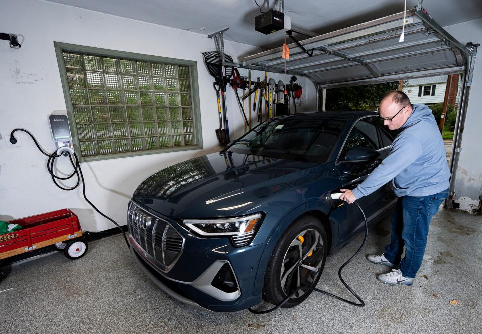 Andrew Tilley charges his Audi e-tron EV with a Level 2 charger in the garage of his Wauwautosa home. Level 2 devices have become the home-charging standard since it can add 25 to 40 miles of driving range an hour, but they also come with an additional cost.