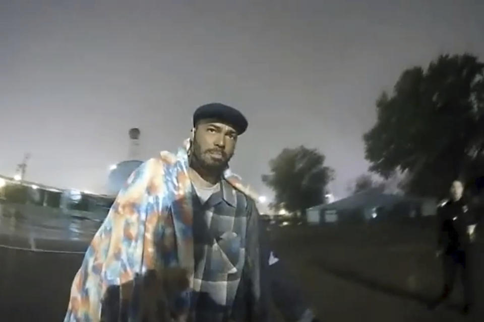 In this image from Altoona Police Department body-camera video, police approach Demetrio Jackson in a parking lot on the border of Altoona and Eau Claire, Wis., on Oct. 8, 2021. Jackson’s 2021 death illustrates an often-hidden way fatal U.S. police encounters end: not with the firing of an officer’s gun but with the silent use of a medical syringe. (Altoona Police Department via AP)