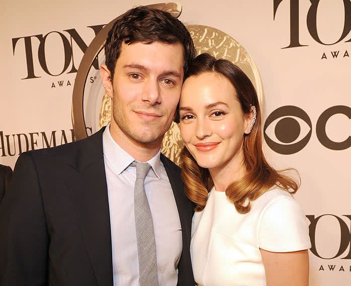 Closeup of Adam and Leighton lean in for a photo on the red carpet