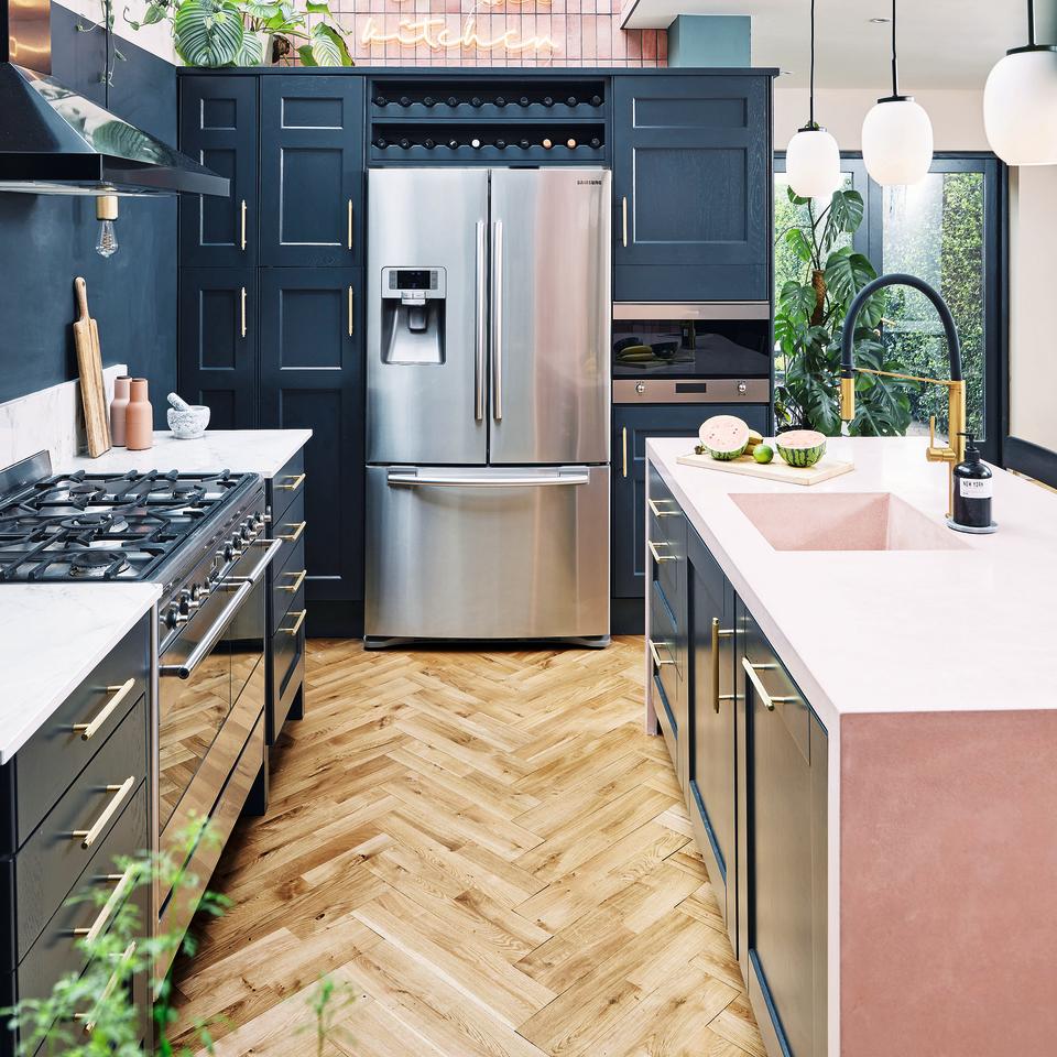 Navy kitchen with pink kitchen island.