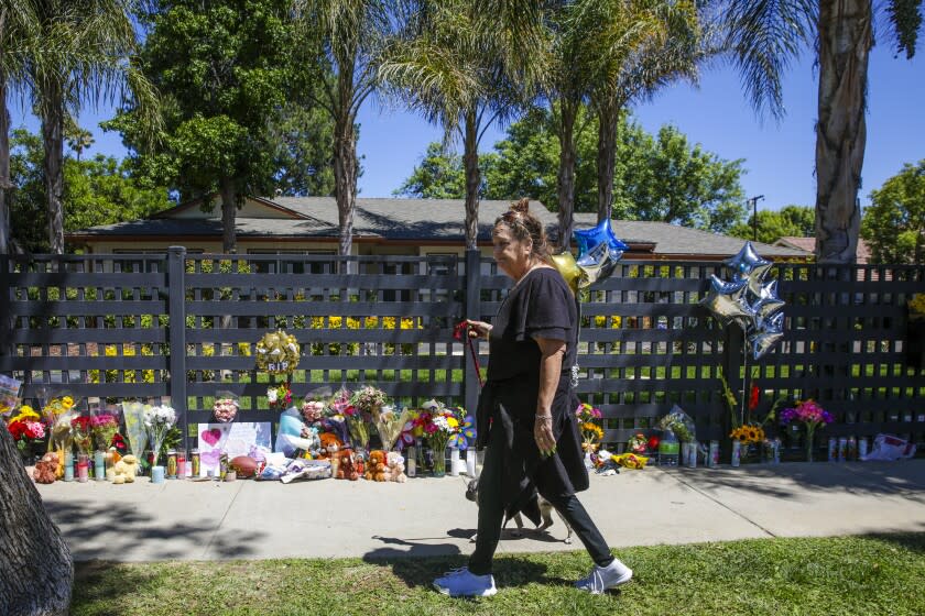 West Hills, CA - May 11: Local residents stop by a make-shift memorial for 3 children who were admittedly killed by their mother Angela Flores at residence 2000 block of Victory Blvd. on Wednesday, May 11, 2022 in West Hills, CA. (Irfan Khan / Los Angeles Times)