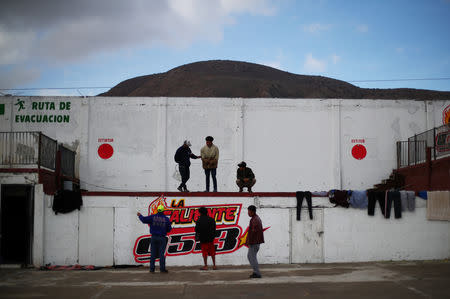 Migrants, part of a caravan of thousands from Central America trying to reach the United States, rest after moving to a new temporary shelter in Tijuana, Mexico, November 30, 2018. REUTERS/Hannah McKay