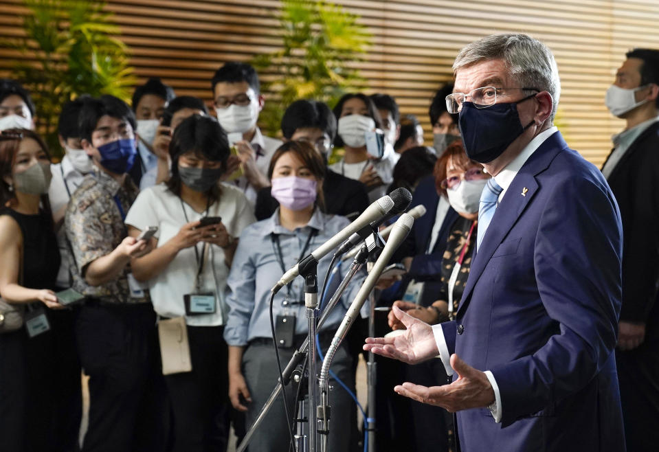 International Olympic Committee President Thomas Bach, right, speaks to journalists after meeting Japanese Prime Minister Yoshihide Suga at the prime minister's official residence in Tokyo, Japan, Wednesday, July 14, 2021.(Kimimasa Mayama/Pool Photo via AP)