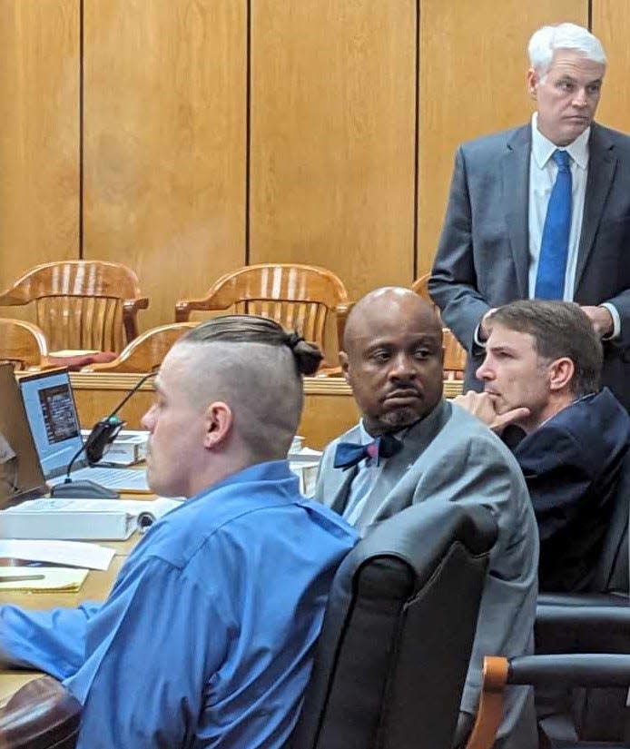 Capital murder defendant Corey Allen Trumbull, far left, is in 78th District Court at a table with Wichita County Public Defender Will Hull, middle, while Wichita County Assistant District Attorney Kyle Lessor sits nearby on Tuesday, Aug. 22, 2023. Wichita County DA John Gillespie stands during a break in Trumbull's trial.