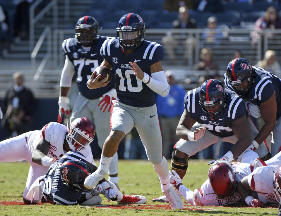 File- This Oct. 28, 2017, file photo shows Mississippi quarterback Jordan Ta'amu (10) carrying the ball for a 49-yard touchdown run during the first half of an NCAA college football game against Arkansas in Oxford, Miss. Ta’amu has emerged as the starter at Mississippi after filling in for the injured Shea Patterson last season. Ta’amu completed nearly 67 percent of his passes for 1,682 yards and 11 touchdowns and earned the full-time job in the offseason after Patterson decided to transfer to Michigan. (AP Photo/Thomas Graning, File)