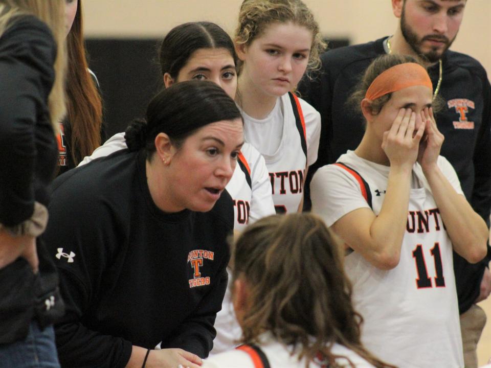 Taunton coach Gretchen Rodrigues talks with her team during a timeout in a non-league game against New Bedford.