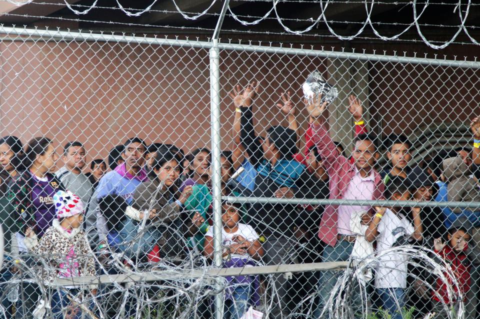 In this March 27, 2019, file photo, Central American migrants wait for food in a pen erected by U.S. Customs and Border Protection to process migrant families and unaccompanied minors in El Paso, Texas. (Photo: ASSOCIATED PRESS)