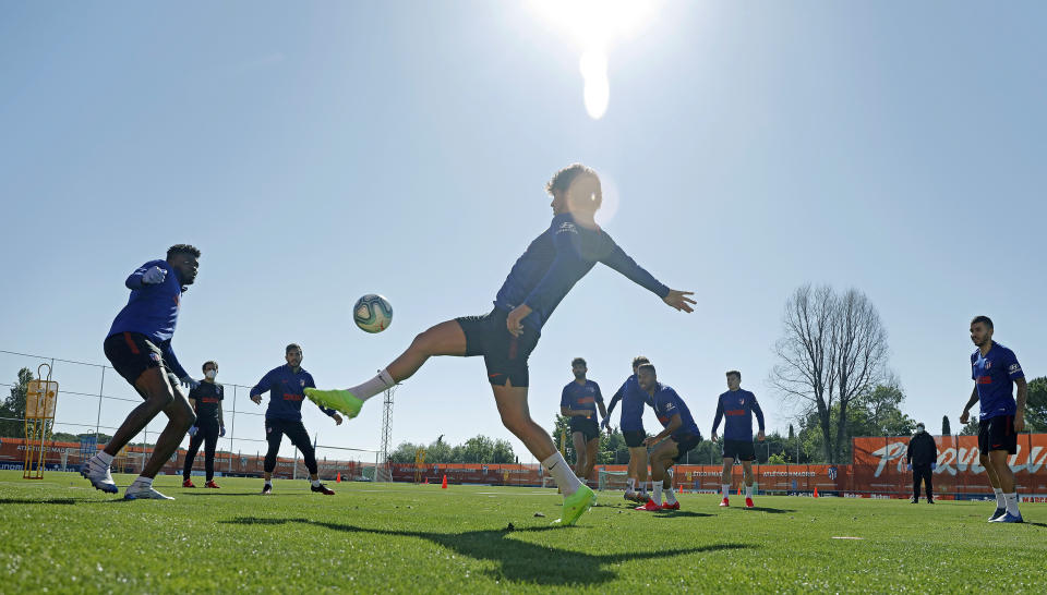 In this photo provided by Atletico Madrid, team players take part in the first group training session in Madrid, Spain, Monday May 18, 2020. All Spanish league clubs can begin group training sessions this week despite stricter lockdown restrictions remaining in place in parts of Spain because of the coronavirus pandemic. (Atletico de Madrid via AP)