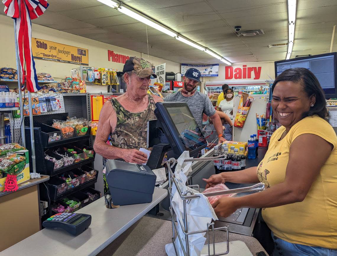 Shoppers check out of Adams Food Center Thursday morning. Customers got a $50 grocery voucher from 34N22, a pro-Herschel Walker PAC. Walker is the Republican nominee for U.S. Senate. 07/28/2022