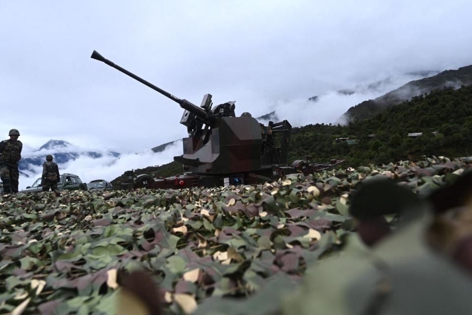 An Indian Army soldier sits inside an upgraded L70 anti aircraft gun in Tawang, near the LAC in the northeast Indian state of Arunachal Pradesh in October 2021 (AFP via Getty Images)