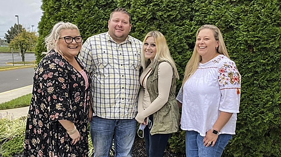 In this photo taken in October 2020, Jennifer Lannon, second from right, poses for a photo with her brother Chris Whitman, second from left, and sisters, Sarah Whitman, far left, and Kim Bermudez in Blackwood, N.J. Lannon's body and three other people were found in a vehicle in a parking garage at Albuquerque International Sunport, New Mexico's largest airport, on March 5. Her ex-husband, 47-year-old Sean Lannon of Grants, New Mexico, said he confessed to killing16 killings in all, including the four found at the airport. (Sharon Whitman via AP)