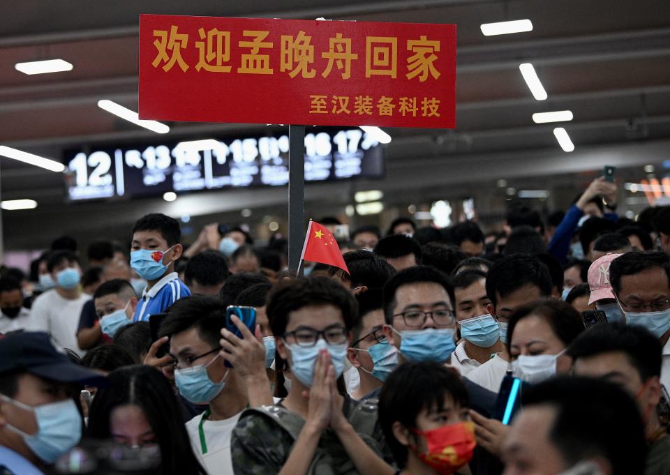 Supporters wait for the arrival of Huawei executive Meng Wanzhou at the Bao'an International Airport in Shenzhen on September 25, 2021. - Huawei executive Meng Wanzhou returned to China on September 25, 2021, shortly after two Canadians released from prison in China also arrived in Calgary, ending a bitter diplomatic row that has poisoned ties for three years. (Photo by Noel Celis / AFP) (Photo by NOEL CELIS/AFP via Getty Images)