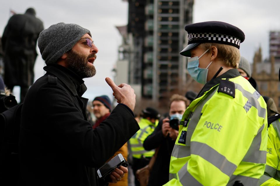 Protestors remonstrate with Police offices during an anti-COVID-19 lockdown demonstration outside the Houses of Parliament in Westminster, central London on January 6, 2021. - Britain toughened its coronavirus restrictions on Tuesday, with England and Scotland going into lockdown and shutting schools, as surging cases have added to fears of a new virus variant. (Photo by Tolga Akmen / AFP) (Photo by TOLGA AKMEN/AFP via Getty Images)