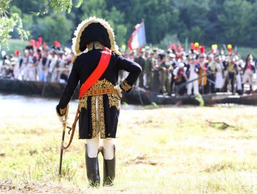 Paris Sorbonne University's professor Oleg Sokolov stands with his sabre and looks at his troops on June 23 on the banks of the river Neman in Kaunas, central Lithuania, as he plays Napoleon Bonaparte during a historical reenactment of Bonaparte's June 24, 1812 assault on Tsarist Russia