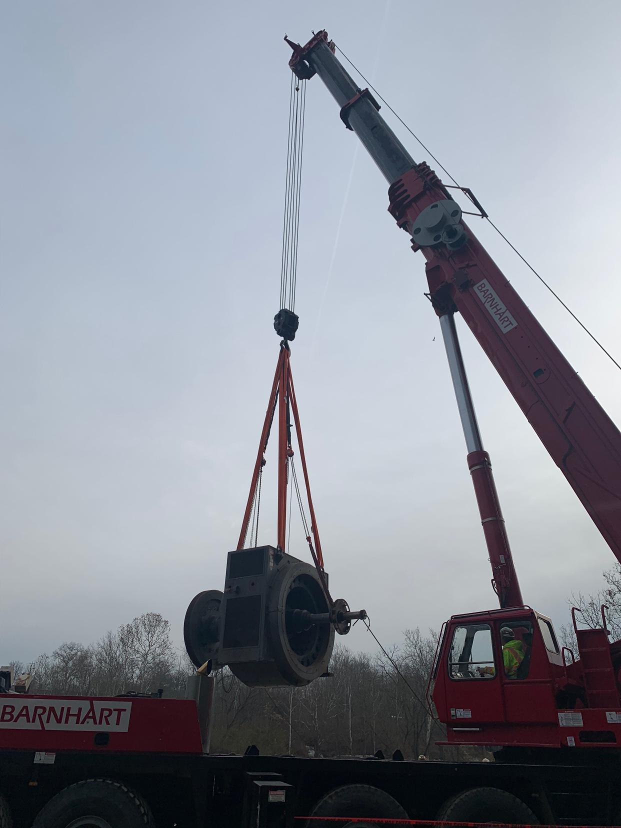 Hydro-turbines are lifted from beneath the O'Shaughnessy Dam for refurbishing as part of a city green-energy project