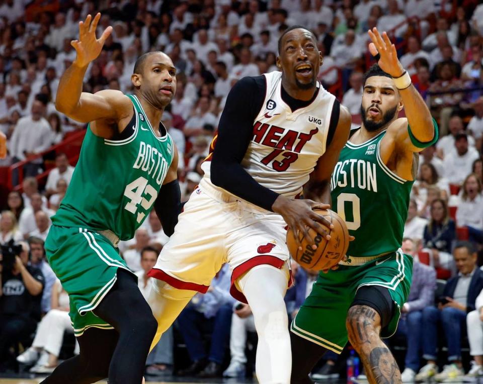 El jugador del Heat Bam Adebayo (13) trata de entrar al aro ante la marca de Al Horford (izq.) y Jayson Tatum, de los Celtics de Boston, en el cuarto partido de las Finales del Este, celebrado el 23 de mayo de 2023 en Miami.