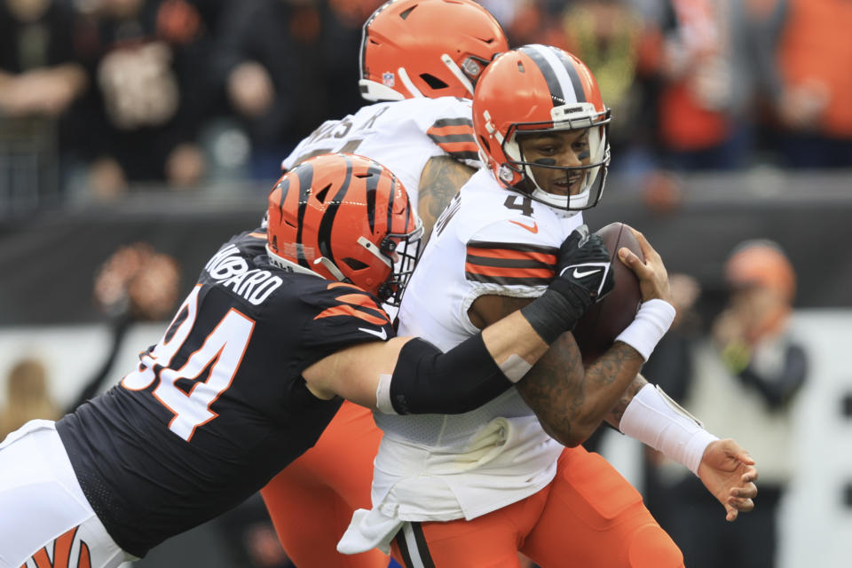 Cleveland Browns quarterback Deshaun Watson (4) is tackled by Cincinnati Bengals' Sam Hubbard (94) during the first half of an NFL football game, Sunday, Dec. 11, 2022, in Cincinnati. (AP Photo/Aaron Doster)