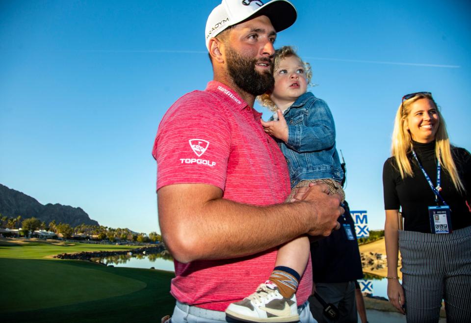 Jon Rahm holds his oldest, 1-year-old Kepa, on the 18th green after winning The American Express on the Pete Dye Stadium Course at PGA West in La Quinta, Calif., Sunday, Jan. 22, 2023. 
