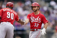 Cincinnati Reds' Max Schrock (32) celebrates with first base coach Delino DeShields (90) after hitting a single during the seventh inning of a baseball game against the New York Mets, Sunday, Aug. 1, 2021, in New York. (AP Photo/Corey Sipkin)