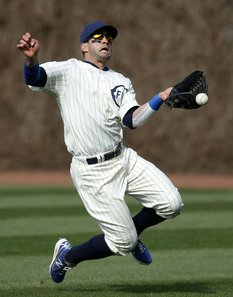 Chicago Cubs right fielder Justin Ruggiano misses the catch on a triple by Arizona Diamondbacks' Aaron Hill, on which two runs scored during the ninth inning of a baseball game at Wrigley Field in Chicago on Wednesday, April 23, 2014. (AP Photo/Andrew A. Nelles)
