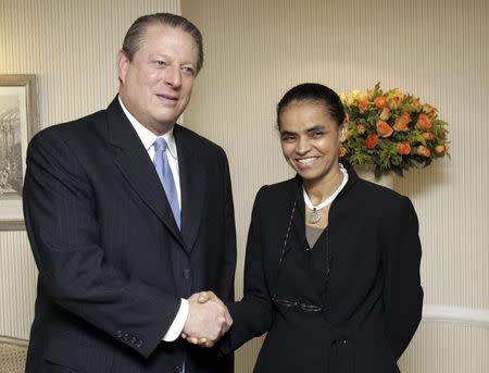 Brazil's then-Environment Minister Marina Silva shakes hands with former U.S. Vice President Al Gore (L) in Sao Paulo in this October 17, 2006 file photo. REUTERS/Paulo Whitaker/Files