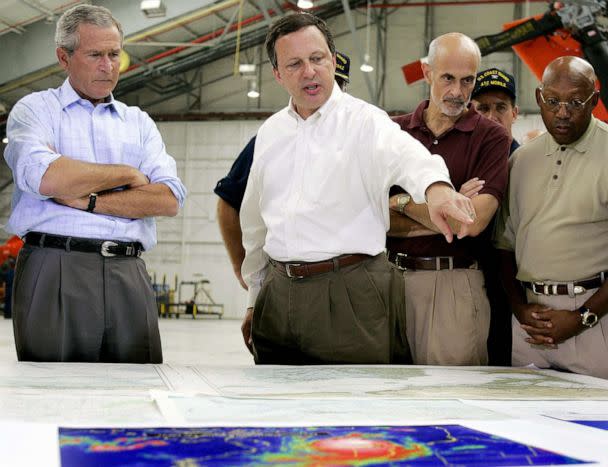 PHOTO: President George W. Bush and Homeland Security Secretary Michael Chertoff (2nd R) get a briefing from Federal Emergency Management Agency (FEMA) chief Michael Brown (C) upon their arrival, Sept. 2, 2005, in Mobile, Ala. (Jim Watson/AFP via Getty Images, FILE)