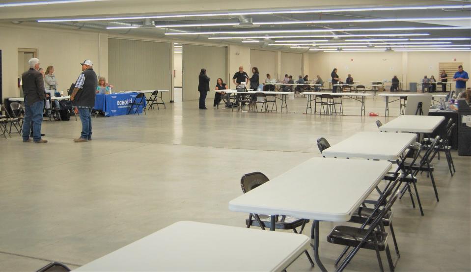 Staff members from the New Mexico Department of Workforce Solutions help people apply for help through the Energy Transition Act Displaced Worker Assistance Fund on Tuesday, May 2 in the Multipurpose Building at McGee Park.