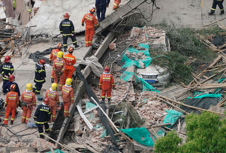 Firefighters work at the site where a building collapsed, in Shanghai, China May 16, 2019. REUTERS/Aly Song