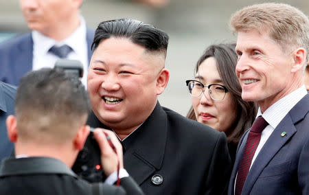 North Korean leader Kim Jong Un poses with Governor of Primorsky Region Oleg Kozhemyako as he arrives at the railway station in the Russian far-eastern city of Vladivostok, Russia, April 24, 2019. REUTERS/Shamil Zhumatov