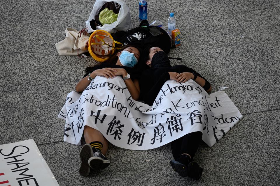 Protesters rest on the floor of Hong Kong's international airport on August 13, 2019, the day after the airport closed due to pro-democracy protests. (Photo: Philip Fong/NurPhoto via Getty Images)