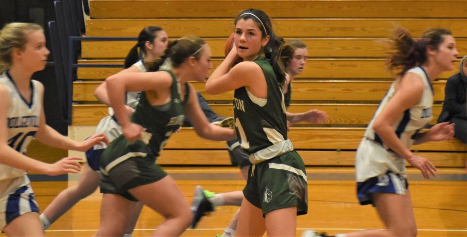 Hamilton Emerald Knight Logan Langel (center) holds a defensive rebound as her teammates and Dolgeville's Blue Devils head up the court Monday.