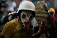 <p>A demonstrator wears a gas mask during a rally against Venezuela’s President Nicolas Maduro in Caracas, Venezuela May 1, 2017. (Photo: Carlos Garcia Rawlins/Reuters) </p>