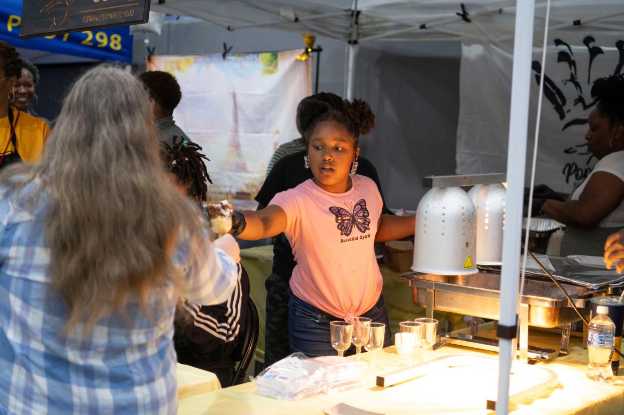 Alivia Boyd helps serve mac and cheese with Pops Gut during The Big Cheese Mac and Cheese Festival at Kellogg Arena on Saturday, April 20, 2024.