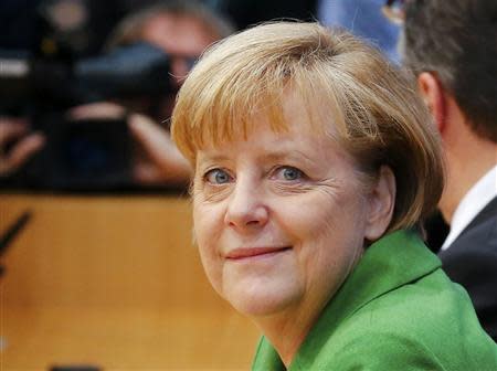 German Chancellor Angela Merkel, leader of the Christian Democratic Union (CDU) attends a news conference after signing a preliminary agreement with Horst Seehofer of the Christian Social Union (CSU) and Sigmar Gabriel of the Social Democratic Party (SPD), in the Bundespressekonferenz in Berlin, November 27, 2013. REUTERS/Pawel Kopczynski