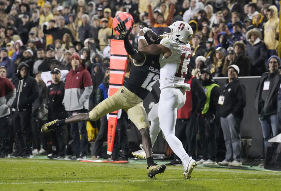 Elic Ayomanor reaches over Travis Hunter to haul in the catch. (David Zalubowski/AP)