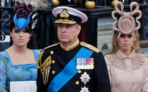 Prince Andrew, center, and his daughters Princess Eugenie, left, and Princess Beatrice at the wedding of Prince William to Catherine Middleton - Credit: Gero Breloer/AP