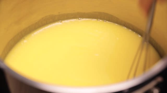 Stirring mango agar agar mixture with a whisk